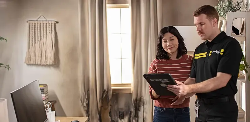 Man and woman reviewing ServiceMaster offerings