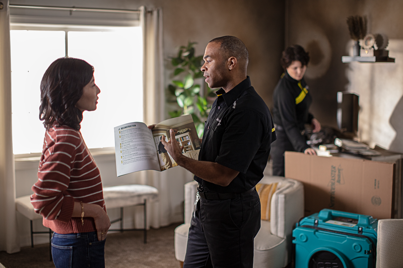 Service Master Team examines smoke damage in house